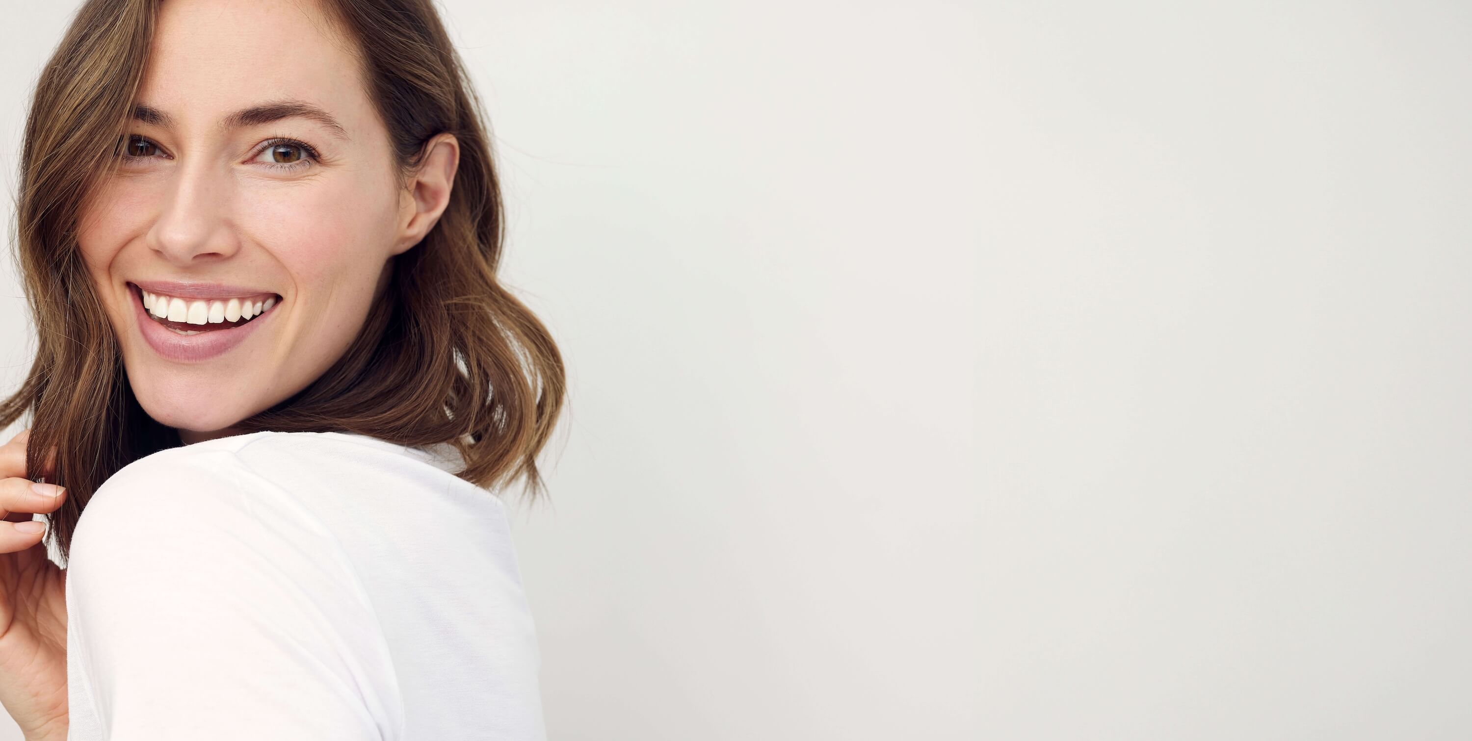 Woman wearing white shirt smiling