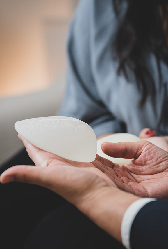 Photo of a plastic surgeon consulting with a patient for implant removal